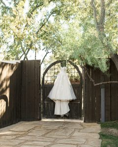 Wedding dress hung on the decorative gate at the Venue.