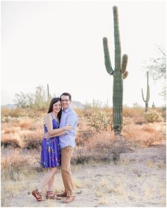 Engaged Man and Woman embracing in front of a saguaro cactus for Phoenix Wedding Photographer