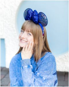 Young lady posing for Disneyland Senior Pictures with Mickey Ears headband
